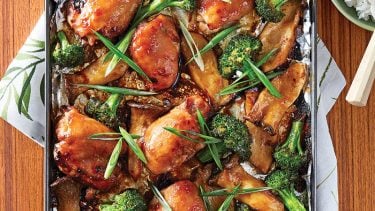 Glazed chicken thighs with miso sauce, roasted broccoli and mushrooms on a sheet pan