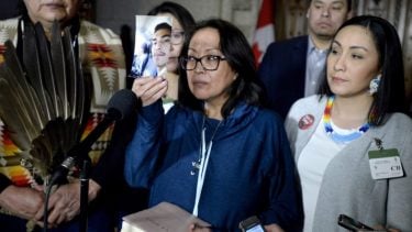 Mother of Colten Boushie holds up photo of her son in the House of Commons