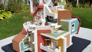 An intricate gingerbread house inspired by Escher's Relativity painting and Cinta Vidal's Gravitas painting.