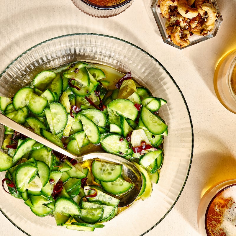 overhead shot of sliced cucumbers in a glass bowl