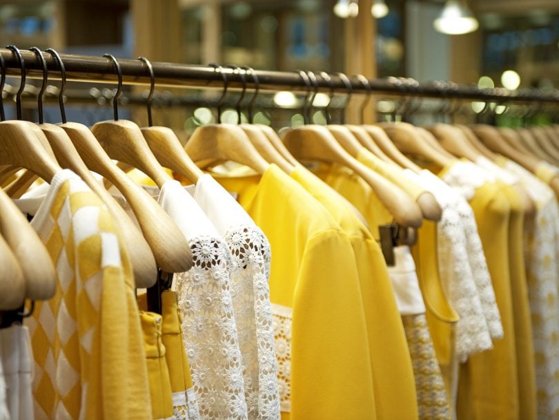 How to Buy Less Clothing: Yellow clothes on a rack