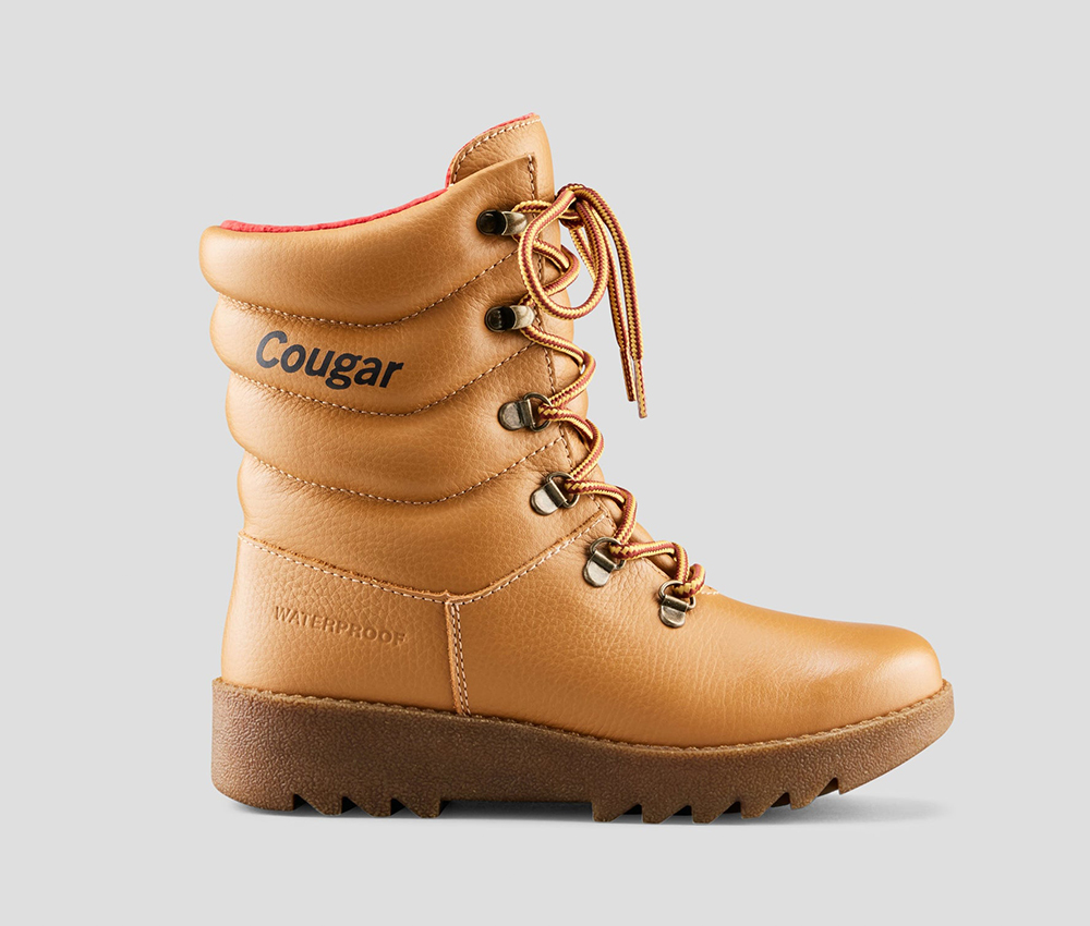A classic Cougar Pillow winter boot in tan seen from the side against a grey background.