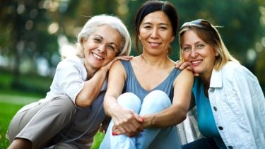 talking about menopause-Three mature ladies enjoying on a nice day outside