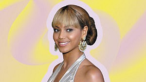 Beyoncé wearing big earrings with bangs.