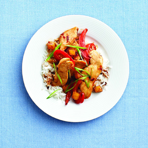 Plate of stir fry on a bed of white rice