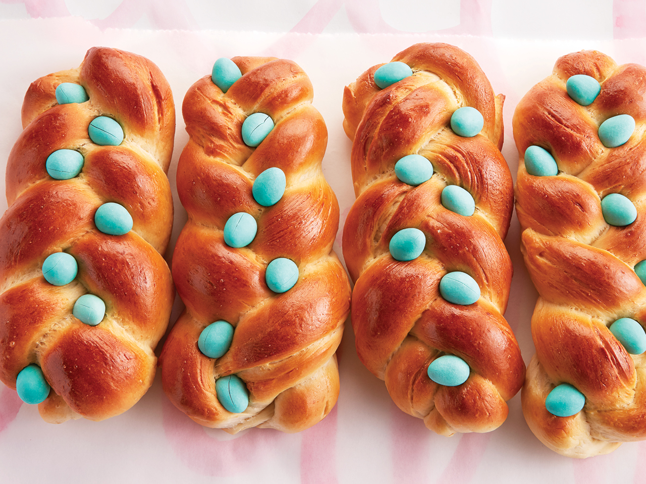 loaves of bread topped with blue mini eggs 