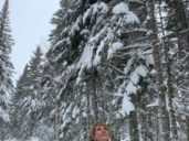 The author standing in a snowy forest to illustrate a piece on forest bathing