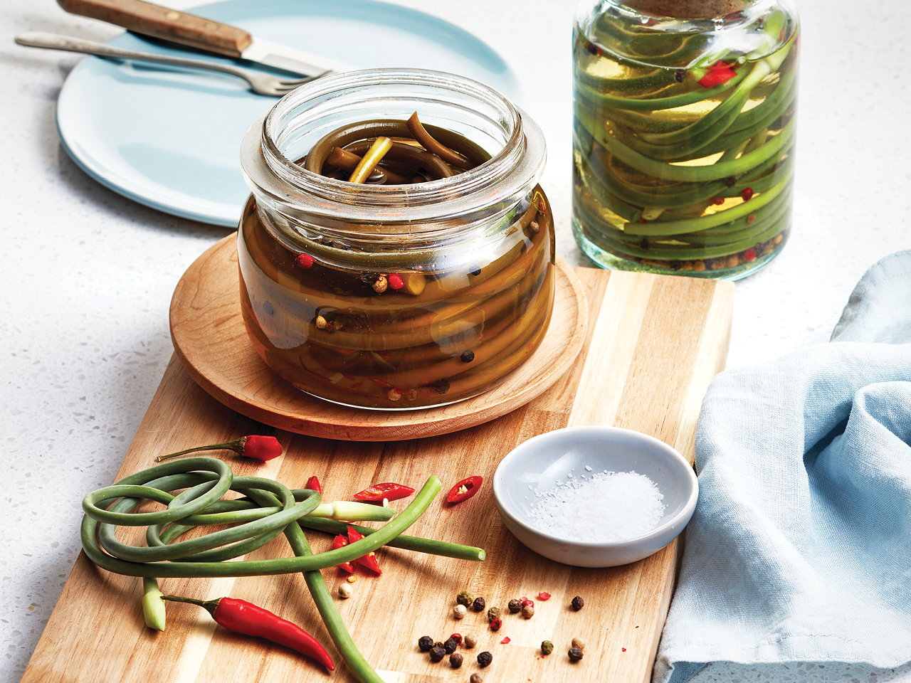 Jars with pickled garlic scapes.
