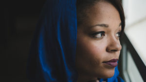 Photo of woman wearing hijab looking out window
