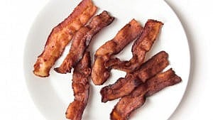 fried bacon on a white plate