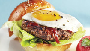 Beef burger served with an egg and steak sauce on brioche buns.