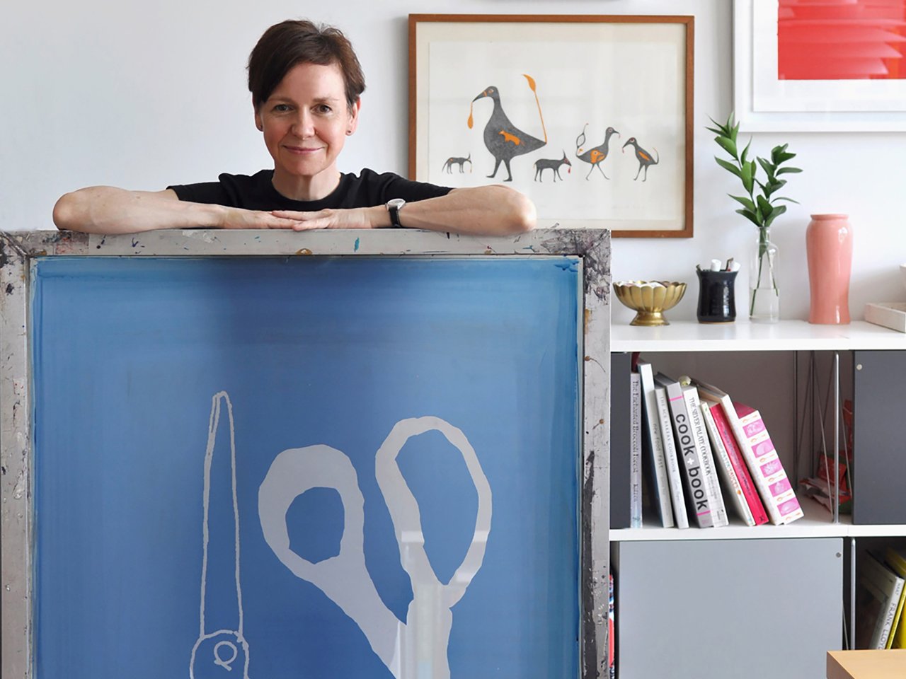 Canadian artist Alanna Cavanagh posing with several of her pieces to illustrate an article on female artists in Canada.