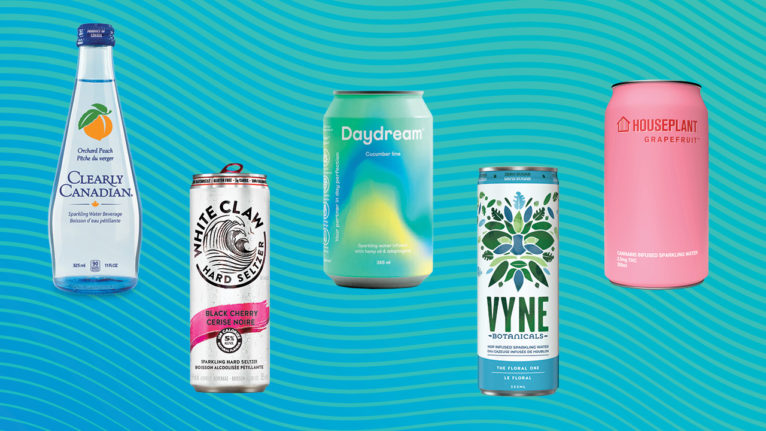 five different sparkling water cans on a green background
