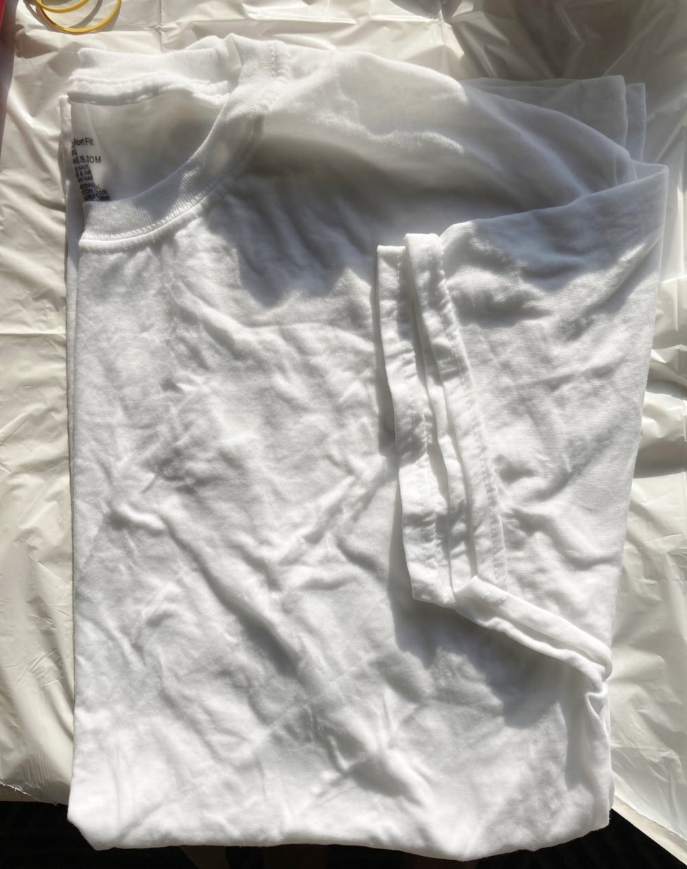 A folded white t-shirt for a piece on how to tie-dye at home
