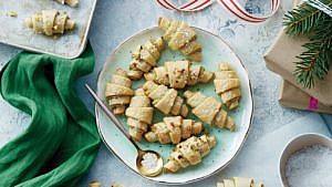 Pistachio-lemon rugelach cookies on round aqua-green plate