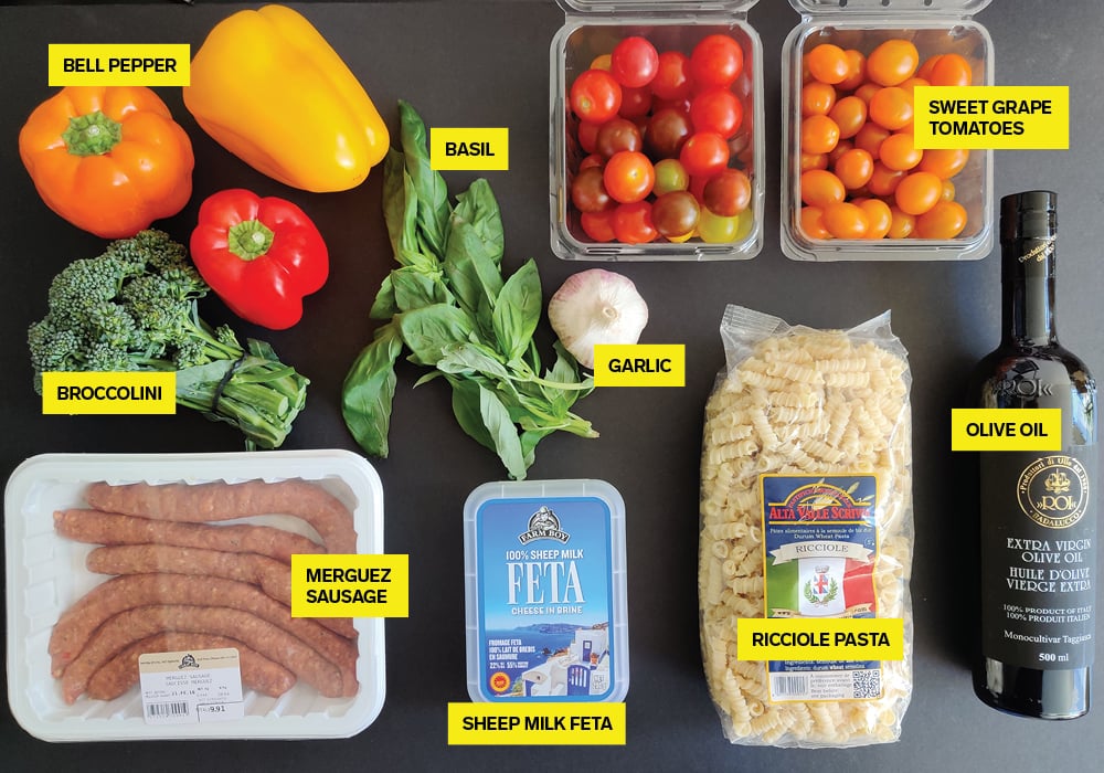 Uncooked ingredients used for feta pasta, photographed and labelled on a counter.