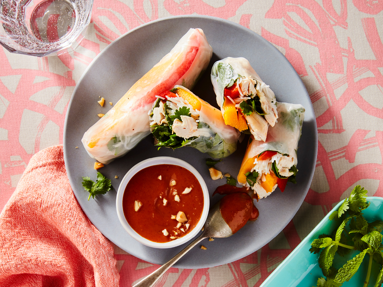 Chicken and mango rice rolls with satay peanut sauce on a plate