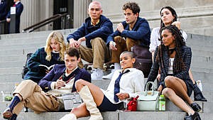 New gossip girl cast sits on the steps in front of the MET.