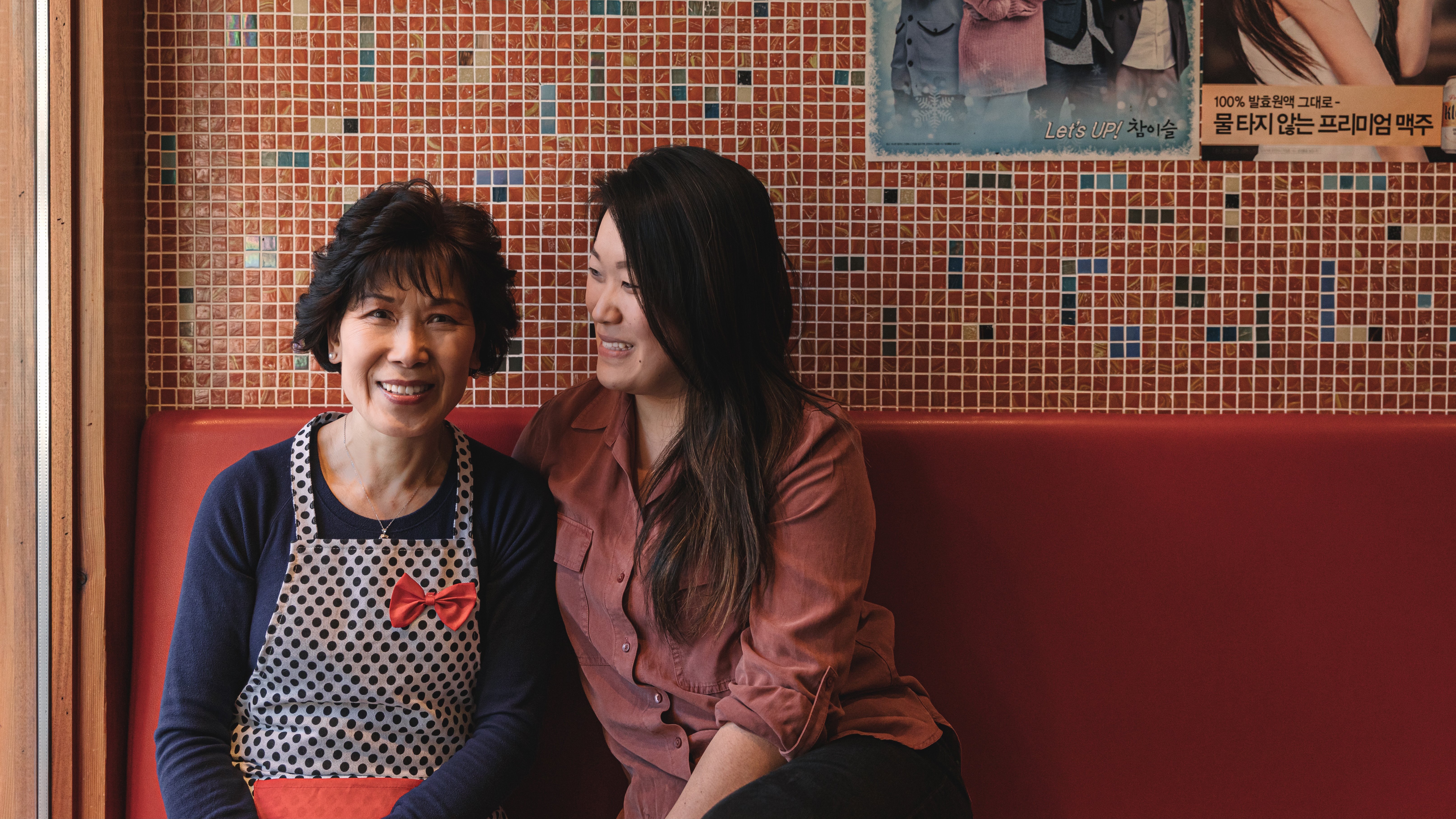 Michelle and Diana Lee of Kimchi Korea House in downtown Toronto sit together on a banquette