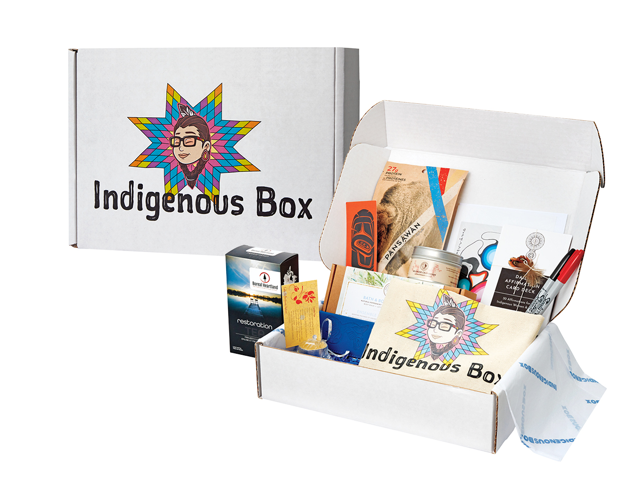An Indigenous Box sits on the left side, closed to show the company's logo, and another sits on the right beside it, showcasing the gifts that are offered inside