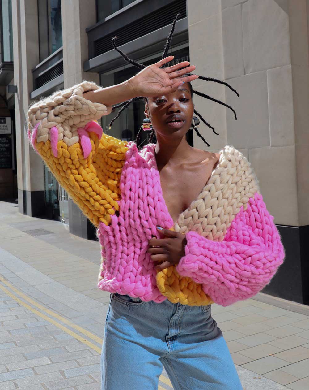 A model wearing an oversized knit cardigan with colourblocked detail from Hope Mcaulay.