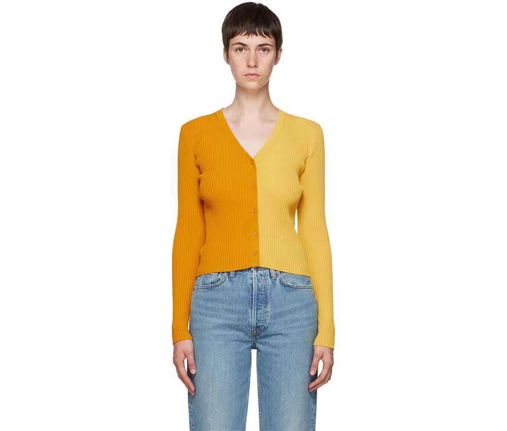A model wearing a colourblocked yellow and mustard v-neck cardigan from Staud.