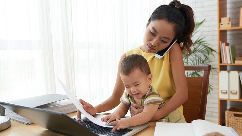 Mother working from home with baby on her lap