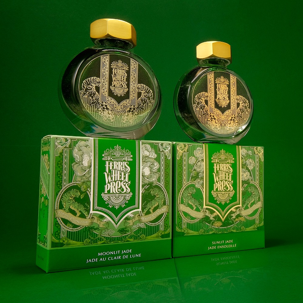 Two inks in green and gold packaging sit against a green background.