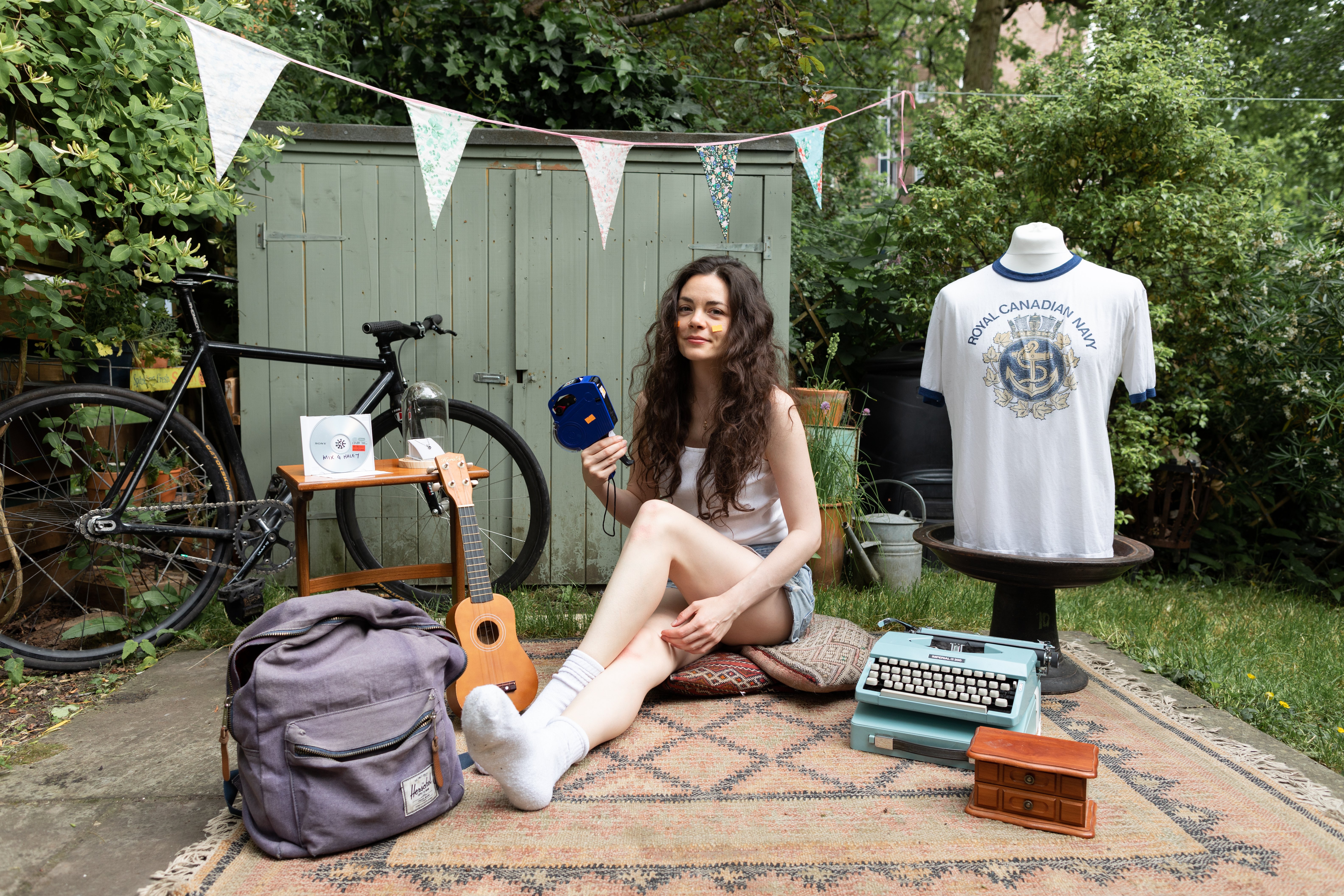 Haley sits in a yard among items from her ex-boyfriends