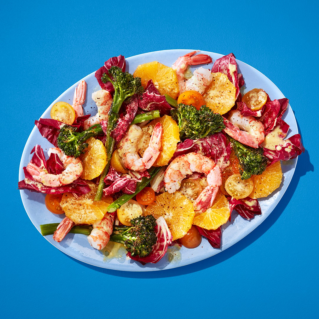 A bowl of shrimp and orange and broccolini salad