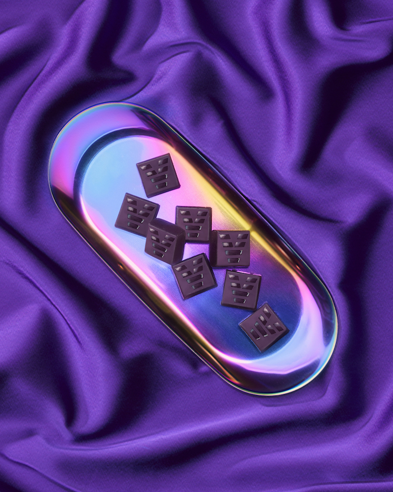 Acevalley CBN chews served on an iridescent tray atop a sheet of purple fabric