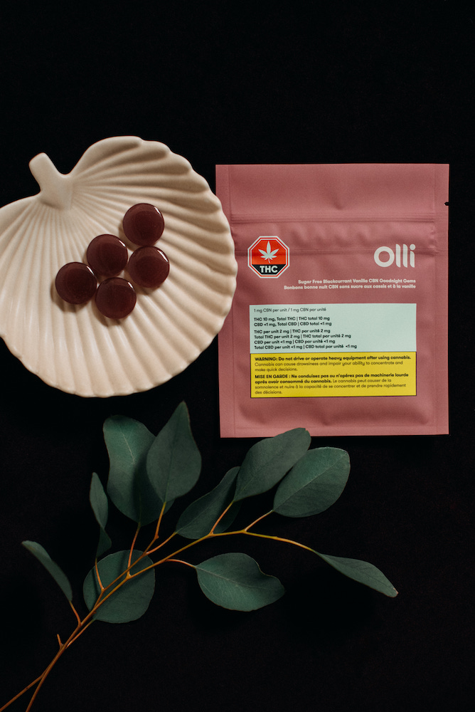 Olli CBN gummies served alongside its packaging and a plant branch