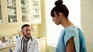 A woman speaks with her doctor at a check-up.