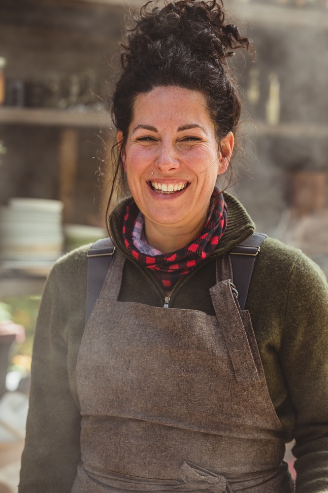 Forager Melissa Finn smiling outdoors for a feature on foraging for spring foods