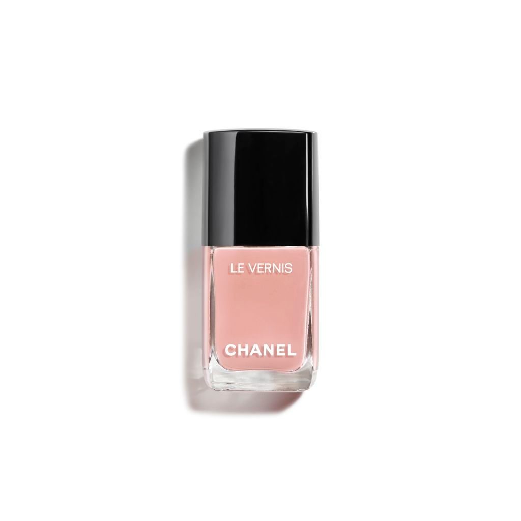 A bottle of Chanel nail polish in Onirique, a peachy shade.