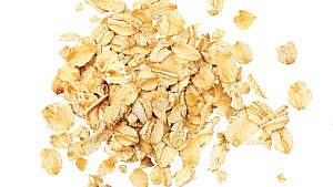 A small pile of rolled oats against a white background