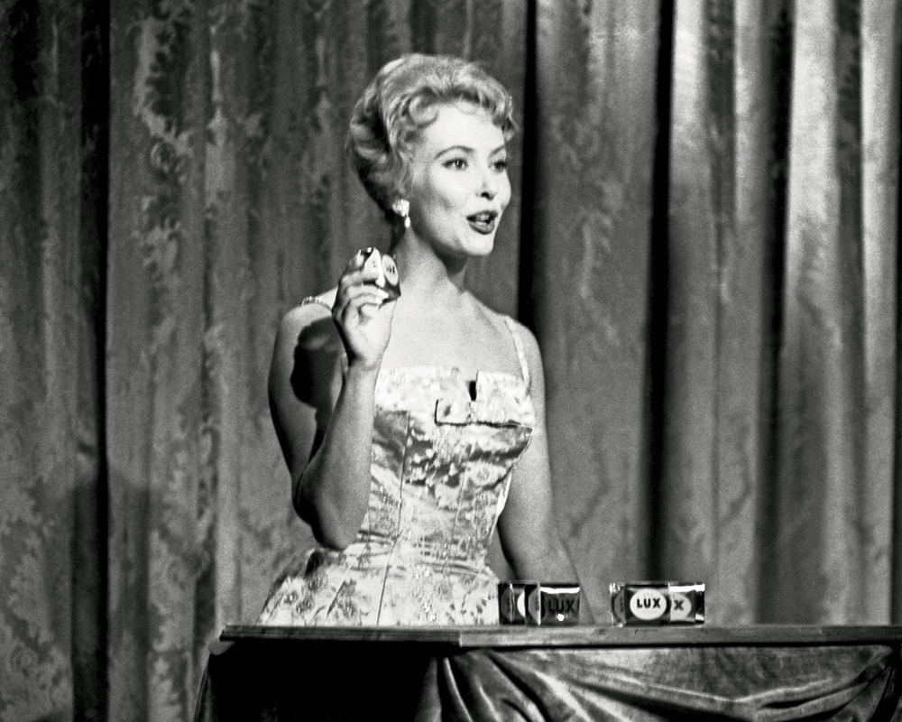 A photo of Joyce Davidson in 1959—she is on air, doing a promotion in a fancy dress
