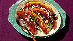 A plate of adobo-roasted plantains with pecans and feta