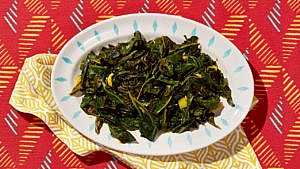 Braised collard greens with turmeric on a serving plate