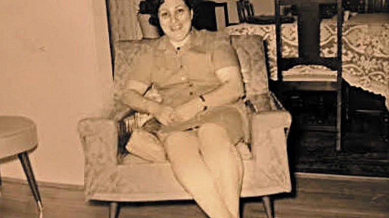 a black and white photo of a woman at a chair