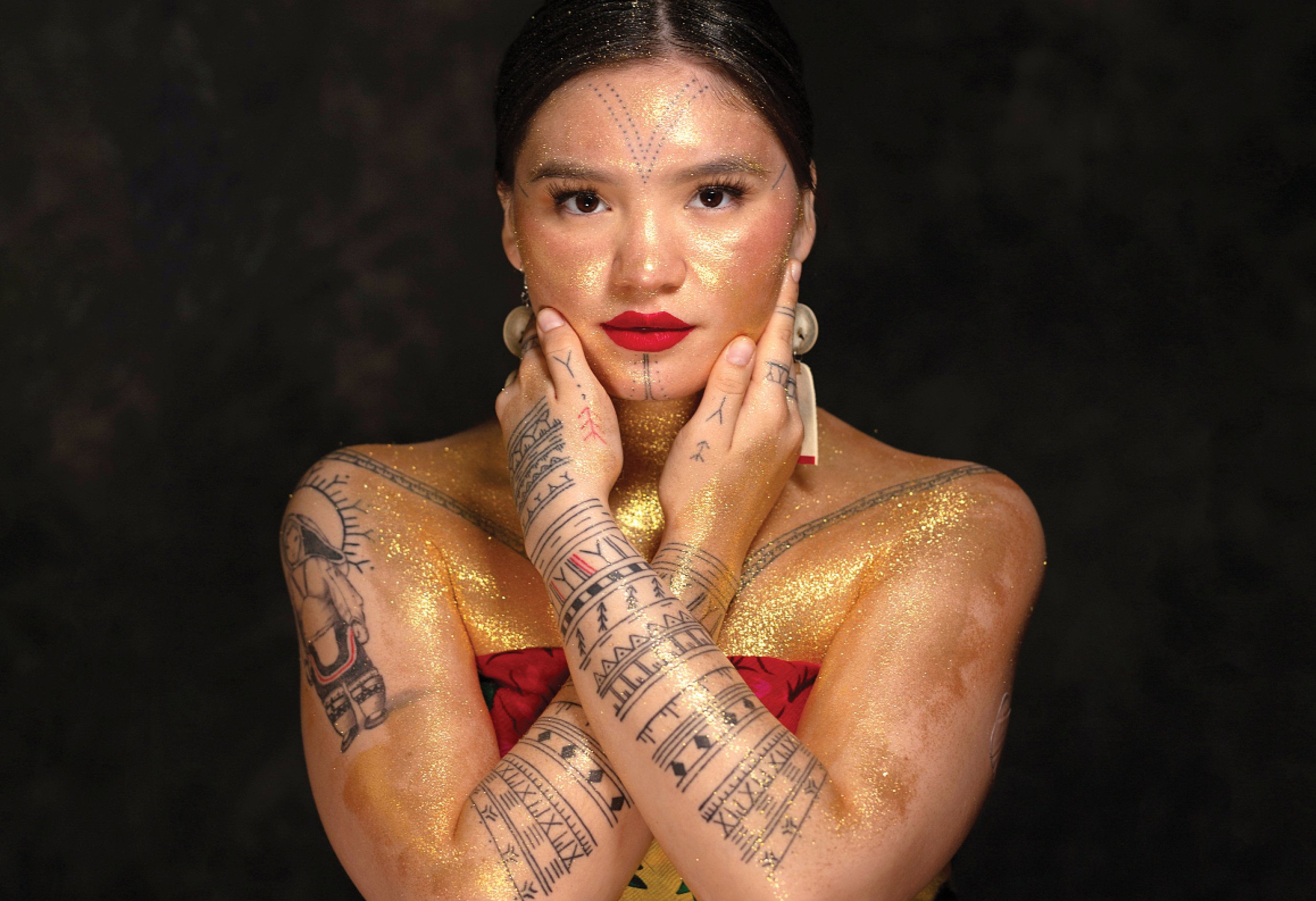 Arsaniq Deer poses with her traditional tattoos: “I’m proud to wear my markings,” she says. (Photo: Cora DeVos)