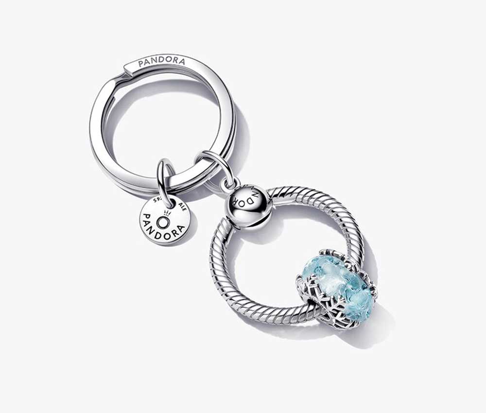 A round silver keyring with a blue snowflake charm from Pandora.