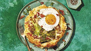 Bubble and squeak—made with leftover steamed cabbage and mashed potatoes—served on a plate with a fried egg