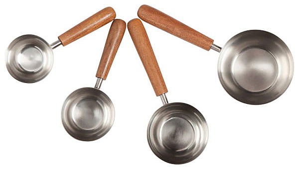 four metal measuring cups with wooden handles