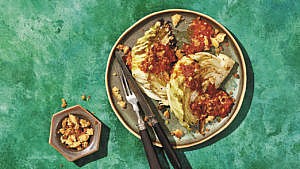 Garlicky tomato grilled cabbage with breadcrums served on a plate