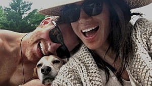 Prince Harry and Meghan and their dog smiling in a selfie