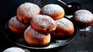 powdered jelly doughnuts on a plate