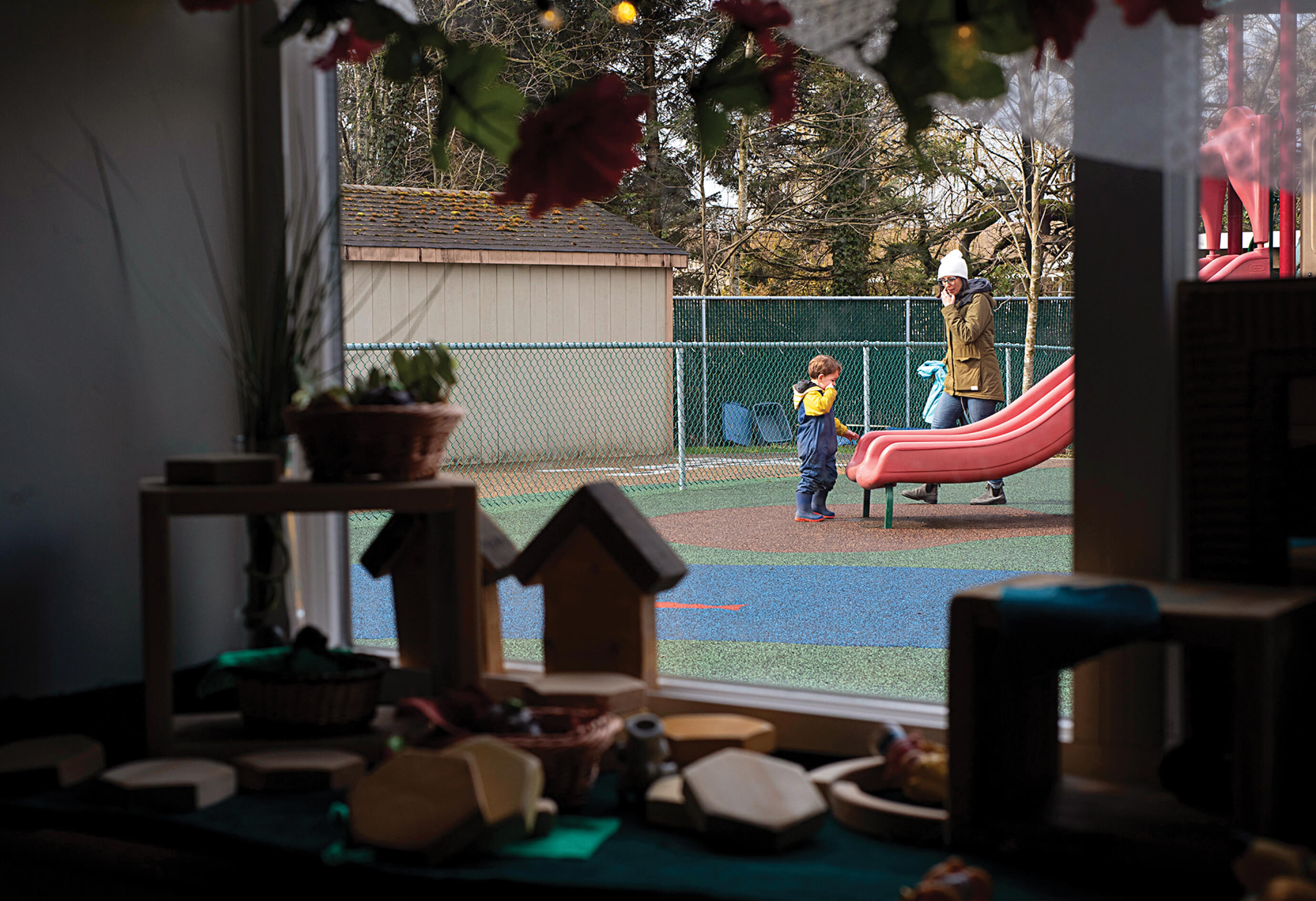 Early Childhood Educator Monique Belanger plays with a child in the playground at A:lmélháwtxw. (Photo: Emma Arkell)