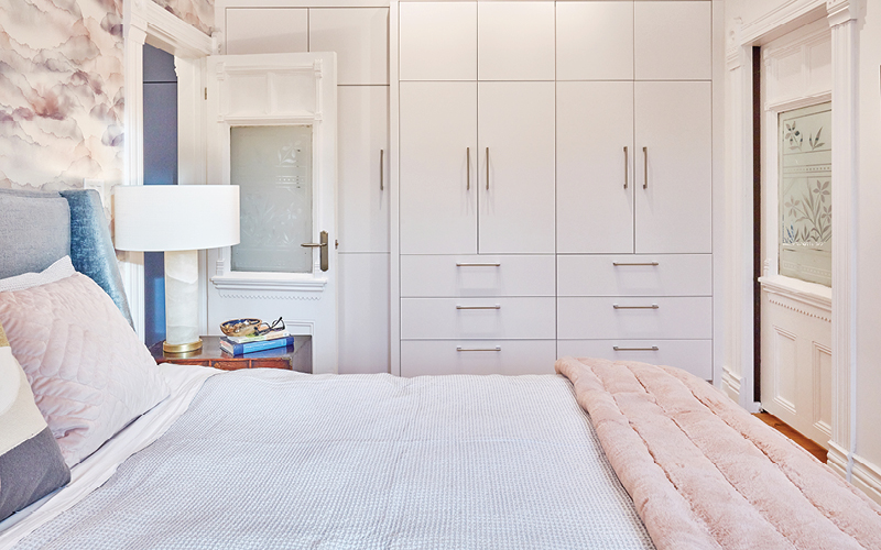 A view of the built-in wall closets in the bedroom