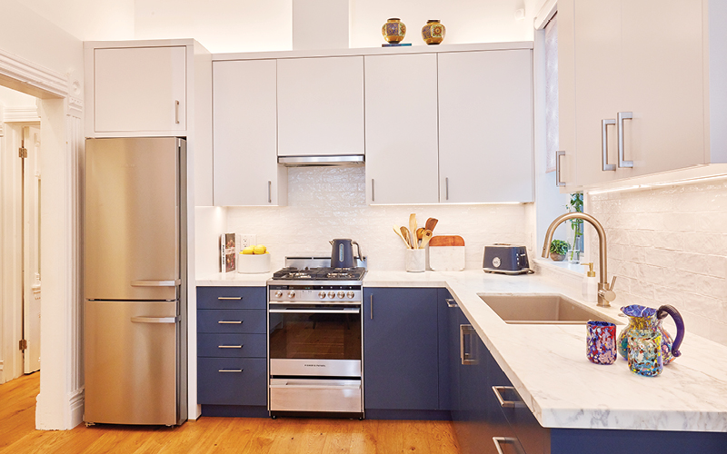 the kitchen, with white countertops and a utensil jar and blue kettle